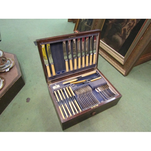 4004 - A Taylor's of Sheffield oak cased part canteen of cutlery together with assorted flatware including ... 