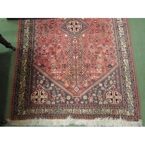 4188 - A pink ground Eastern wool rug, multiple borders with tasselled ends, 158cm x 98.5cm