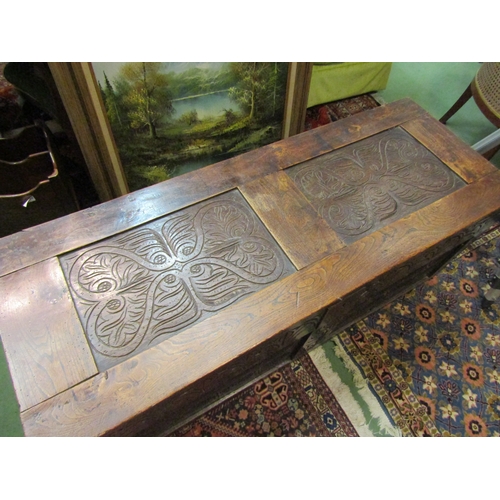 4193 - An early 18th Century carved oak coffer with lunette style carving and scrolled roundels to two pane... 