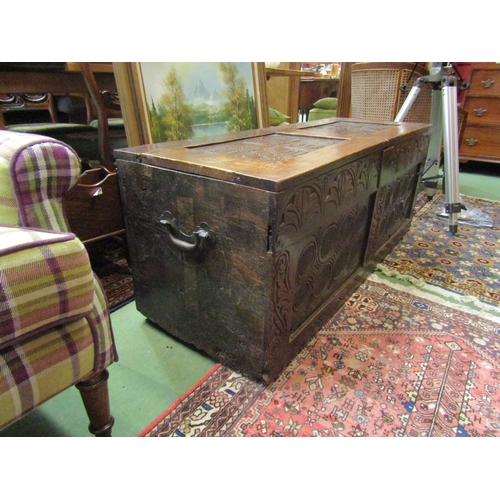 4193 - An early 18th Century carved oak coffer with lunette style carving and scrolled roundels to two pane... 