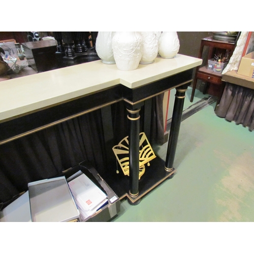 4233 - An Empire style ebonised and gilded breakfront console table, the marble style top over turned pilla... 