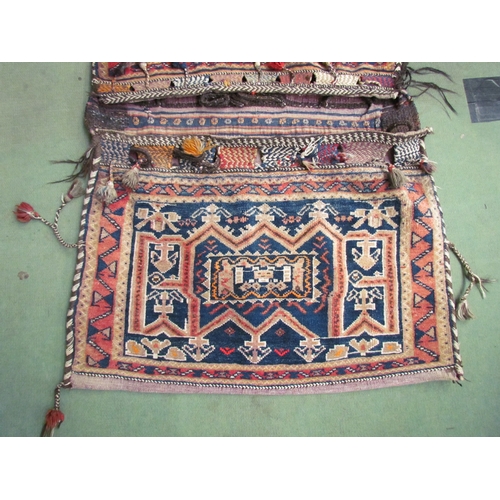 4244 - A vintage hand-knotted Eastern saddle bag, (58cm x 85cm each side)