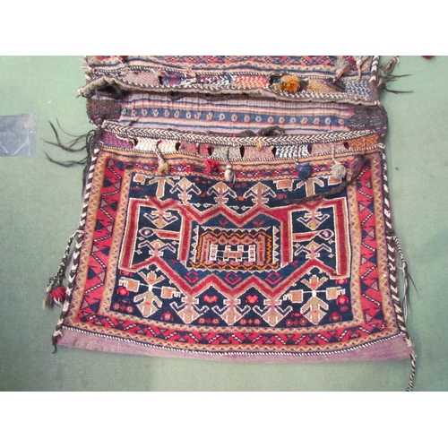 4244 - A vintage hand-knotted Eastern saddle bag, (58cm x 85cm each side)