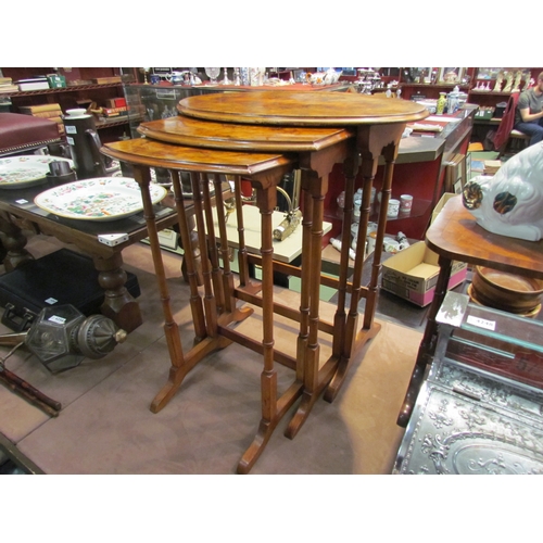 4253 - A burr walnut oval topped nest of three tables, tallest 61cm long x 40cm deep x 69cm high