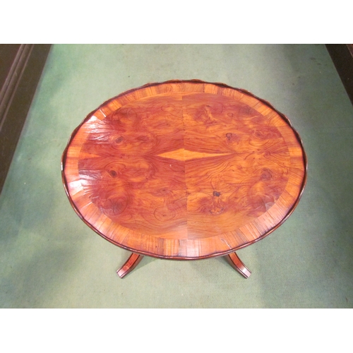 4254 - A George II revival crossbanded yew oval top table with wavy gallery over a ring turned column and p... 