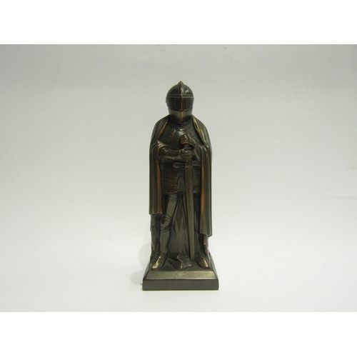 4461 - A novelty bronzed figural table lighter in the form of a knight, 19cm tall