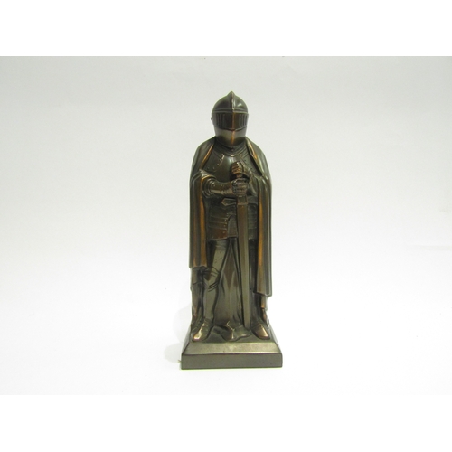 4461 - A novelty bronzed figural table lighter in the form of a knight, 19cm tall