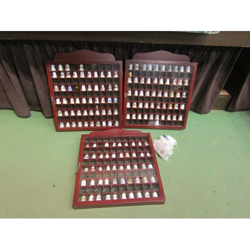 4478 - Three display cases containing ceramic thimbles