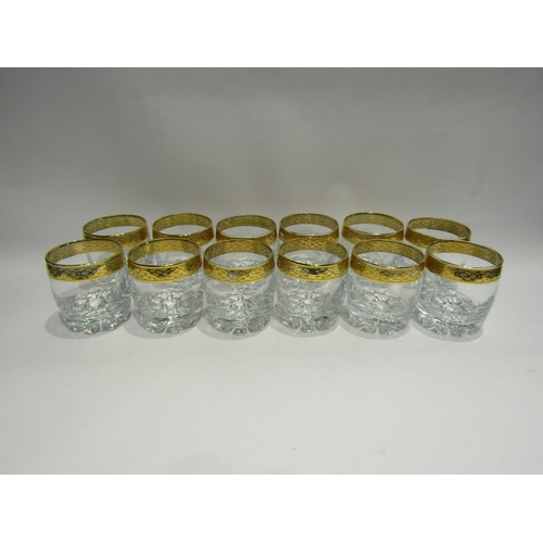 4487 - A set of twelve heavy whisky glasses with gilt rims