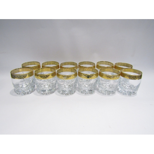 4487 - A set of twelve heavy whisky glasses with gilt rims