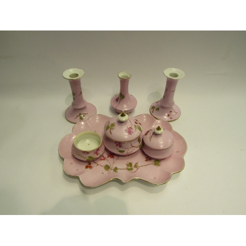 4528 - A hard paste porcelain dressing table set consisting of tray, candlesticks, trinket pots. Pink groun... 