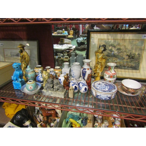 4472 - A group of mainly Oriental ceramics to include resin figurines, dogs of fo, vases, teacup and saucer... 