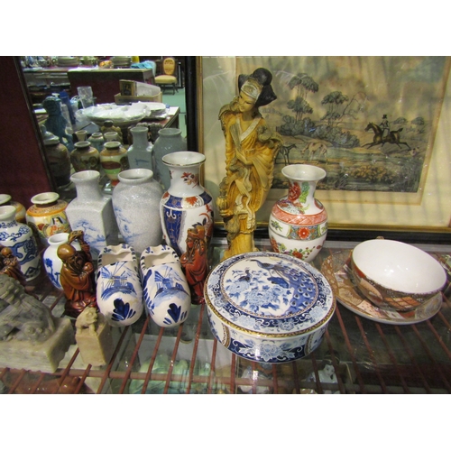 4472 - A group of mainly Oriental ceramics to include resin figurines, dogs of fo, vases, teacup and saucer... 