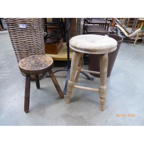 2041 - A stripped elm stool and a carved pine stool