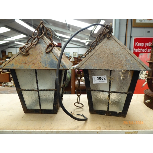 2062 - A pair of wrought iron porch lanterns