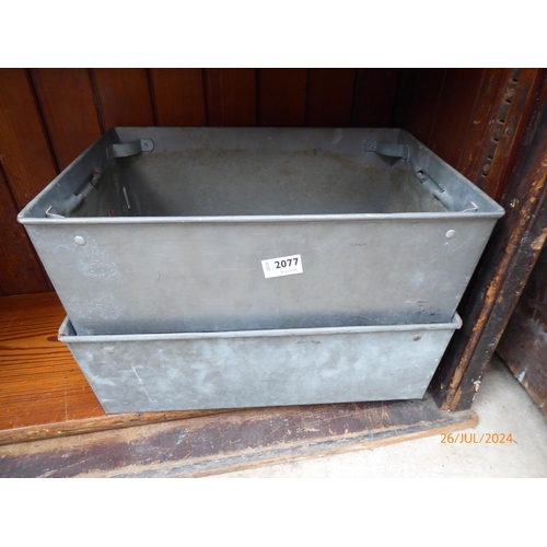 2077 - Two metal twin handled stacking trays