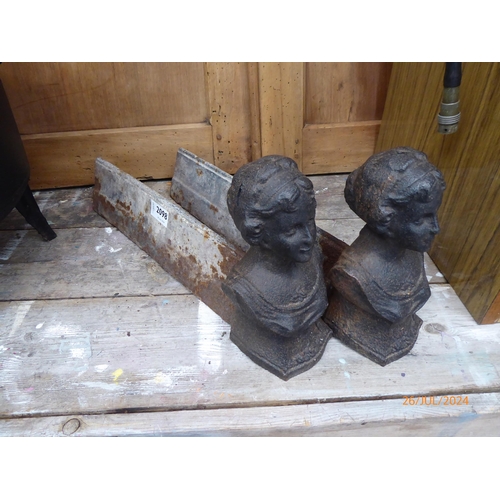 2098 - A pair of cast iron fire dogs with maidens heads