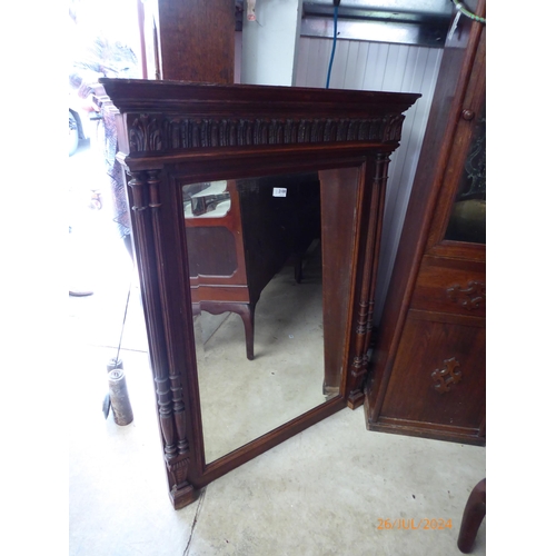 2108 - A late 19th Century oak mirror with bevelled edge and column sides