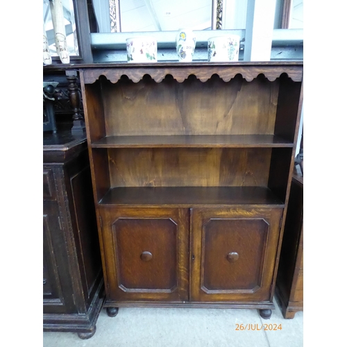 2129 - An 1920's oak bookcase over cupboard