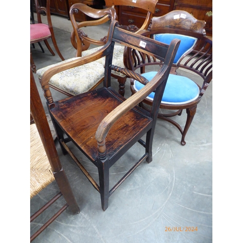 2195 - A Georgian elm seated country elbow chair with rope twist back