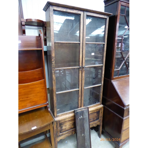 2227 - A 1930's oak and glazed cabinet on stand, one pane missing