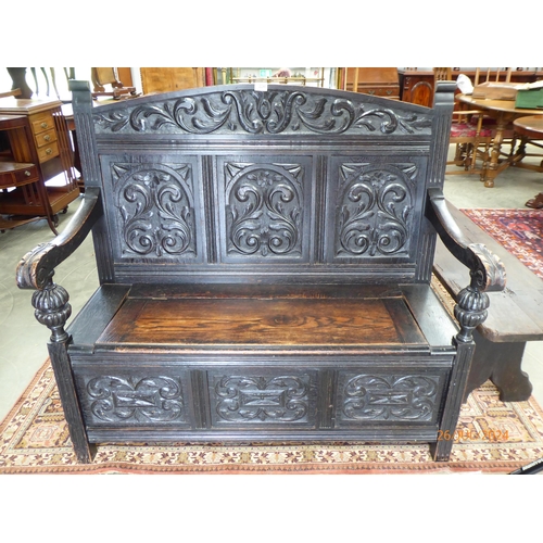 2241 - A Victorian carved oak settle with box seat