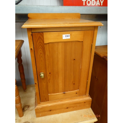 2263 - A nest of three pine tables and pine pot cupboard