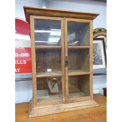 2266 - A Victorian pine and glazed two door cabinet