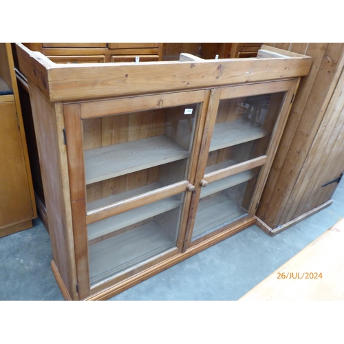 2281 - A Victorian pine and glazed two door bookcase