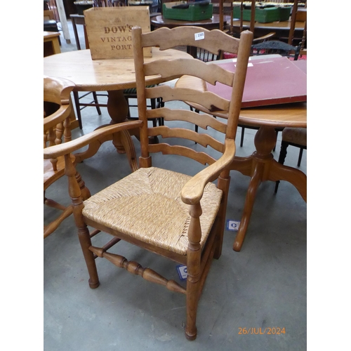 2305 - An oak rush seated ladder back armchair