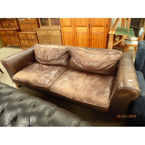 2332 - A worn brown chesterfeild leather sofa