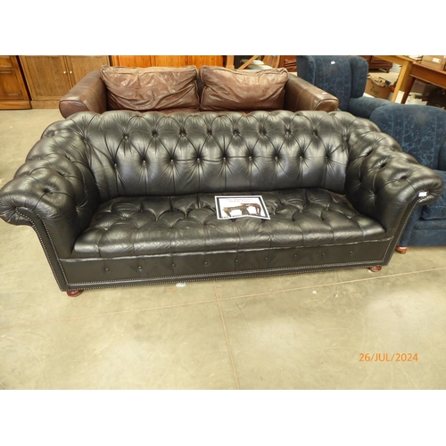 2338 - A deep seated black button leather chesterfeild sofa