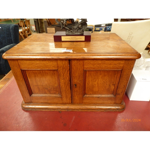 2340 - An Edwardian oak canteen cabinet with two doors, revealing four drawers