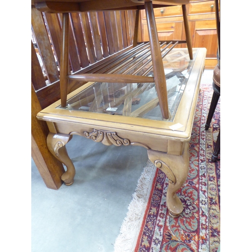 2399 - A glass top coffee table