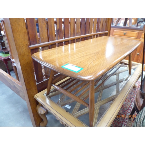 2400 - An Ercol elm coffee table with slatted undertier and splayed legs