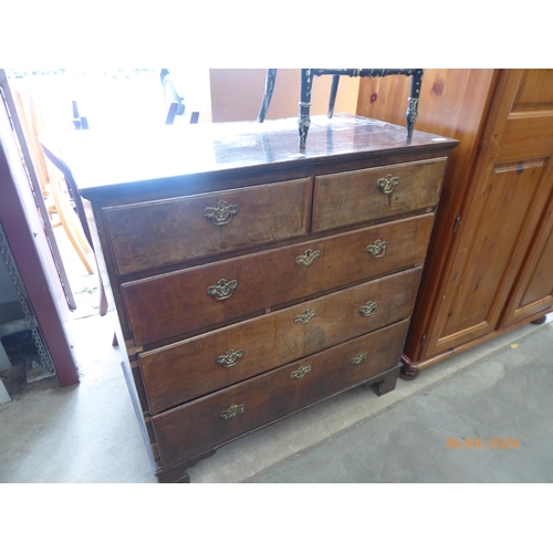 2446 - A Georgian walnut chest of two short over three long drawers, brass handles, on bracket feet, for re... 