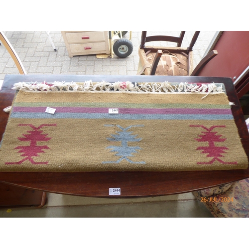 2447 - A tan coloured kilim rug, tasselled fringe