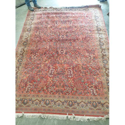 2209 - A hand woven red and blue floral design rug , 249cm x 340cm