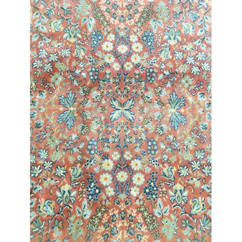 2209 - A hand woven red and blue floral design rug , 249cm x 340cm