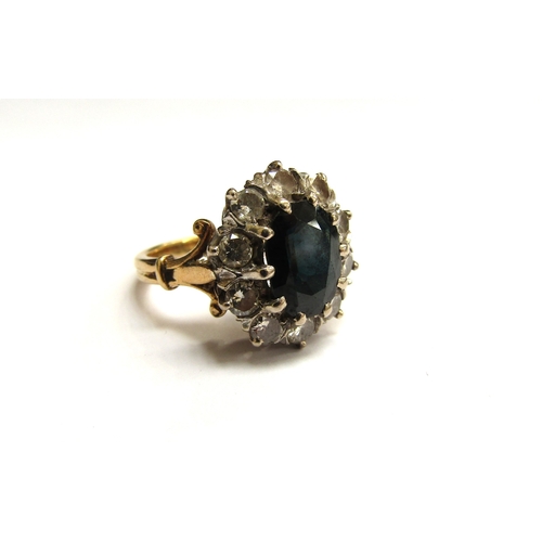 6060 - A sapphire and diamond cluster ring, the central sapphire 10mm x 7mm, framed by ten round cut diamon... 