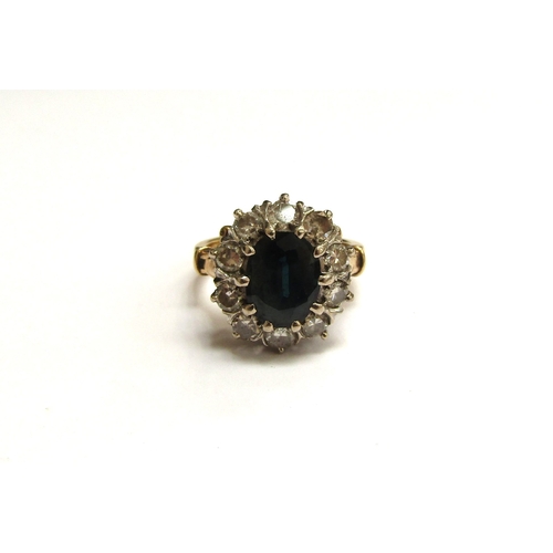 6060 - A sapphire and diamond cluster ring, the central sapphire 10mm x 7mm, framed by ten round cut diamon... 