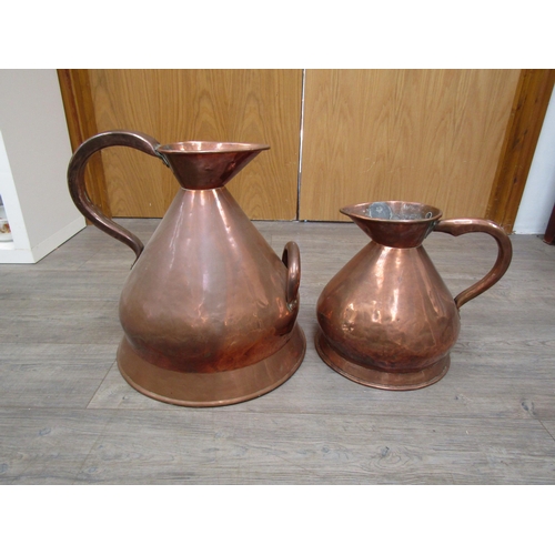 6036 - A Victorian copper 4 gallon twin handled jug and 2 gallon example (2)