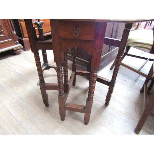 6102 - An oak drop-leaf occasional table with bobbin turned legs, 72cm x 72cm x 58cm