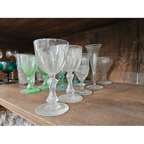 6054 - Twenty four 19th Century and later mixed drinking glasses including Hock, coloured glass, fern tall ... 