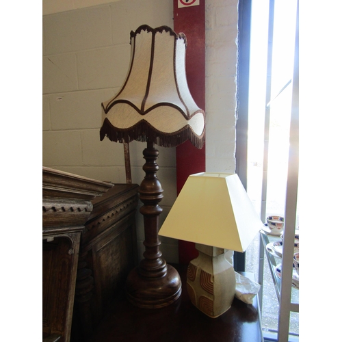 1004 - A studio pottery table lamp and a large turned walnut table lamp