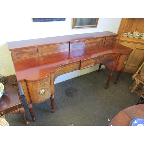 1018 - A Regency mahogany sideboard, shaped front with two central drawers and a pair of convex drawers on ... 