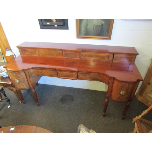 1018 - A Regency mahogany sideboard, shaped front with two central drawers and a pair of convex drawers on ... 