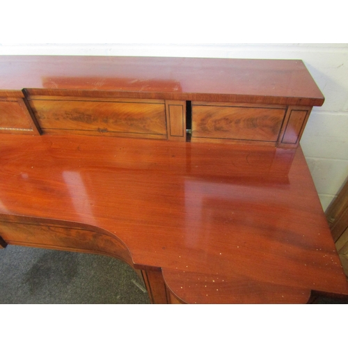 1018 - A Regency mahogany sideboard, shaped front with two central drawers and a pair of convex drawers on ... 