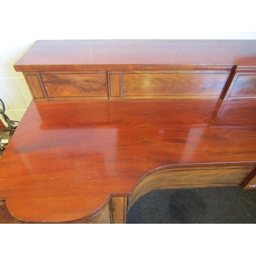 1018 - A Regency mahogany sideboard, shaped front with two central drawers and a pair of convex drawers on ... 