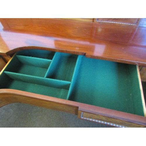 1018 - A Regency mahogany sideboard, shaped front with two central drawers and a pair of convex drawers on ... 